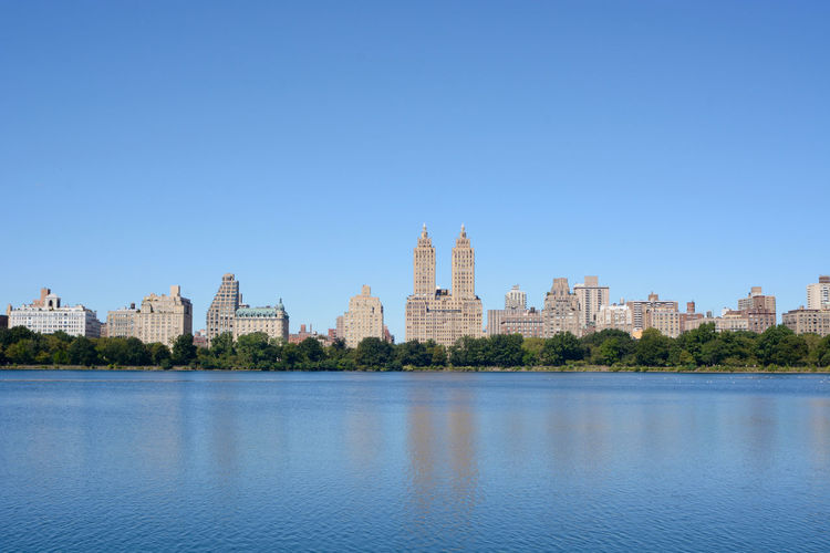 Jacqueline kennedy onassis reservoir at central park against clear blue sky in city