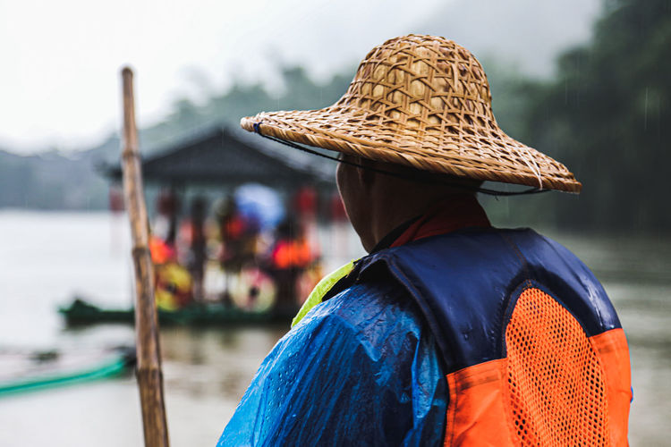 Rear view of man wearing life jacket