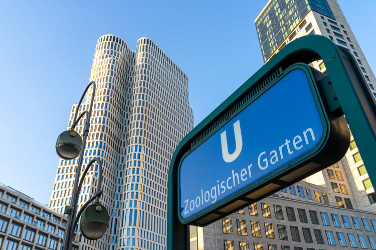 Subway sign agains city skyline