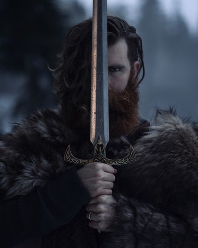 Portrait of bearded viking wielding a sword