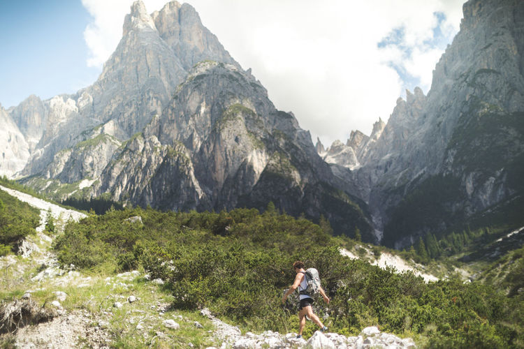 Woman standing on mountain against sky