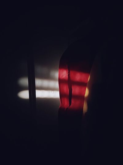 Close-up of illuminated red light in window