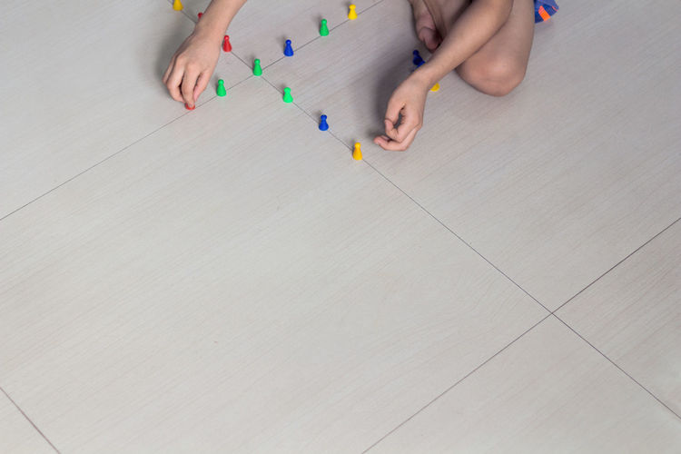 Low section of child on tiled floor