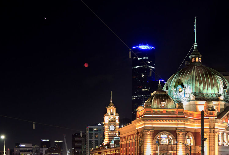 Flinders street railway station against sky in city at night
