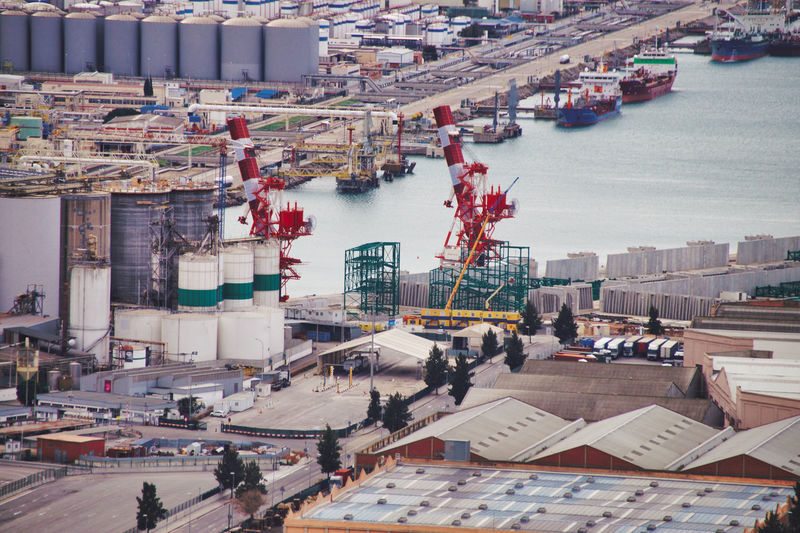 High angle view of boats and industry at harbor
