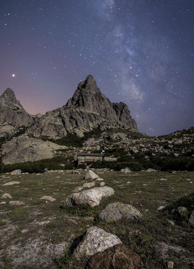 Scenic view of rocks at night against sky