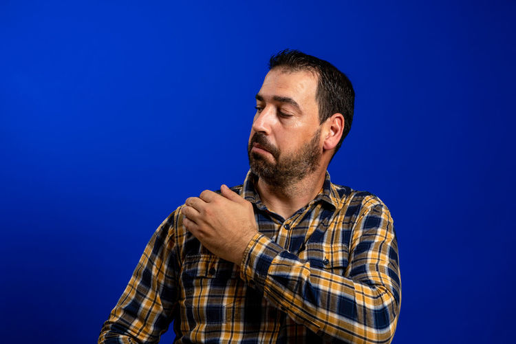 Portrait of man against blue background