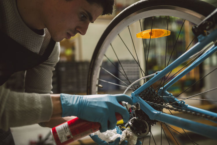 Mechanic oiling a bike chain