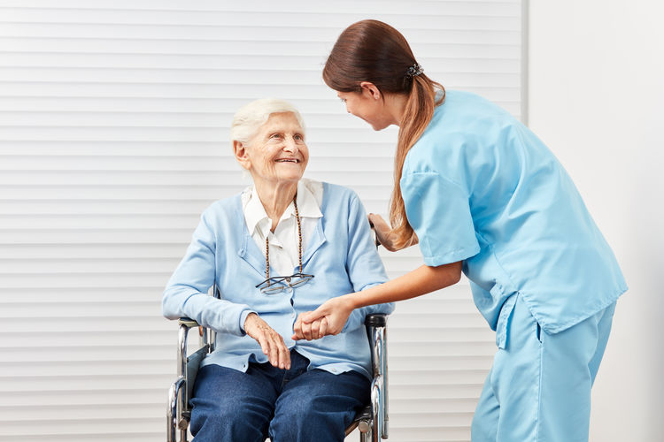 Smiling nurse with senior woman at rehab