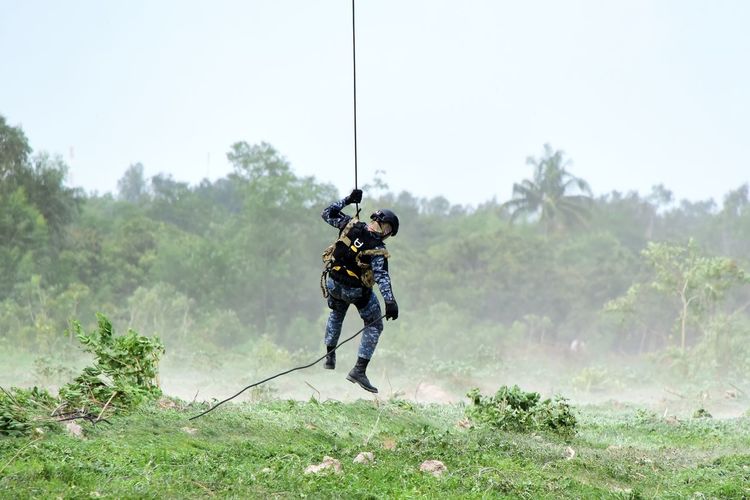 Military tactical exercise and hoisting personnel