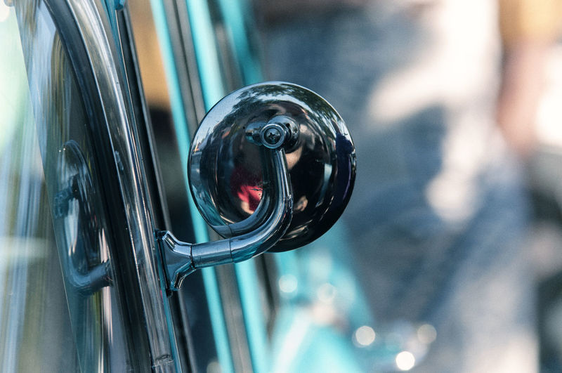 Close-up of side-view mirror of vintage car