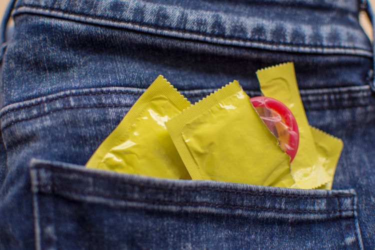 Close-up of condoms in back pocket of jeans