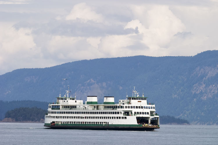 A ferry boat on a washington state waterway is used to transport cars and passengers.
