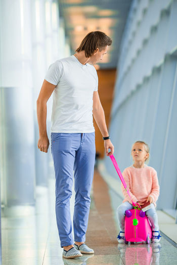 Full length father with daughter at airport