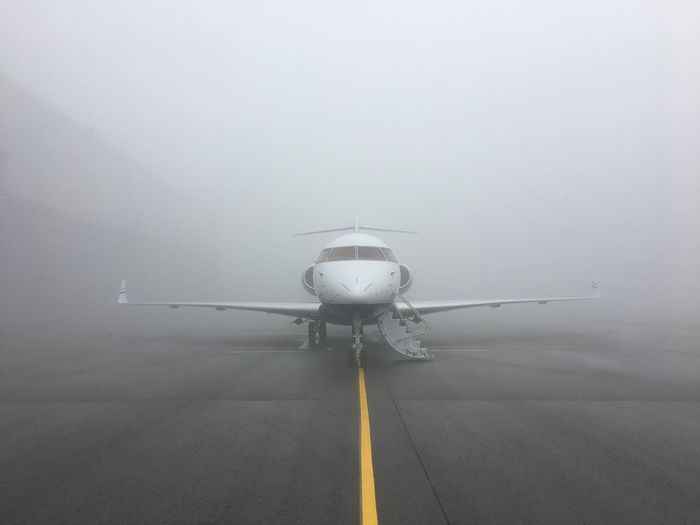 Airplane at runway during foggy weather
