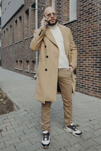 Full length of man standing on wall