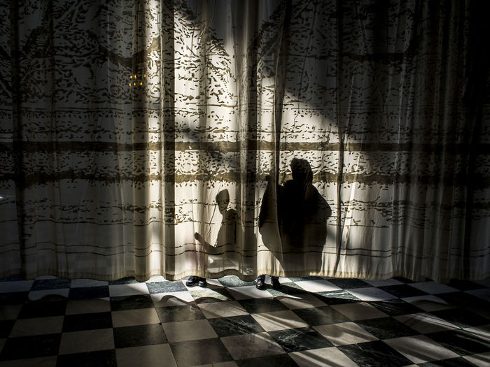Shadow of people on curtain