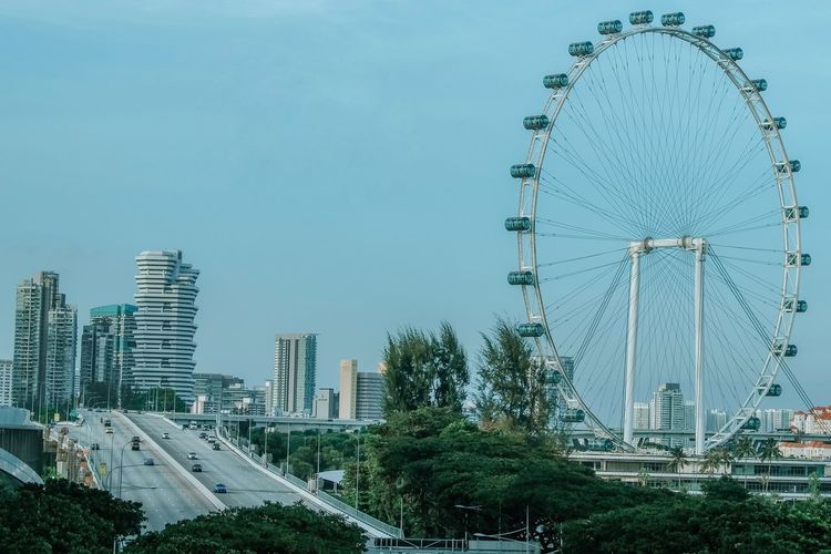 Ferris wheel in city against sky