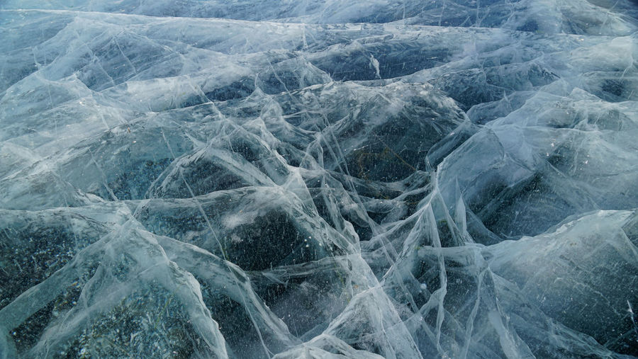 Transparent ice of lake baikal with a pattern of cracks