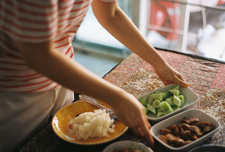 Midsection of man preparing food in kitchen