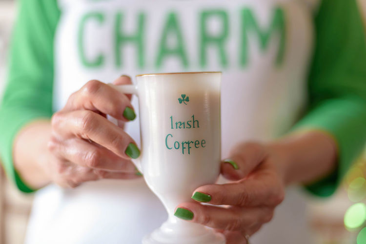 Midsection of woman holding coffee cup