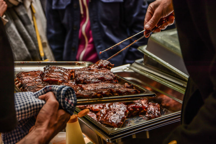 Low angle view of man holding barbecue grill