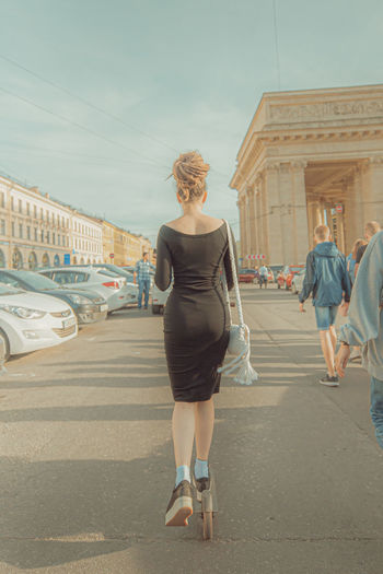 Full length rear view of woman walking in city