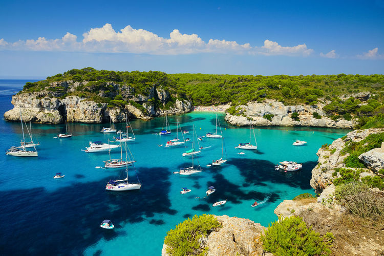 High angle view of sailboats in sea against sky