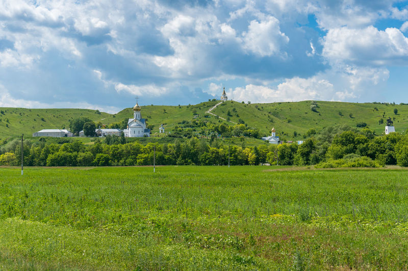 Scenic view of field and monastery against sky
