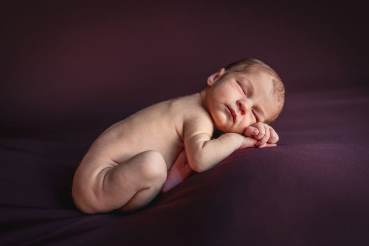 A newborn baby sleeping peacefully. newborn session concept