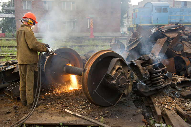 Worker welding scrap metal