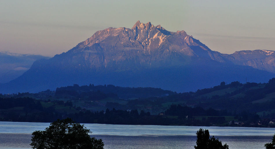 Scenic view of mountains against sky at sunset