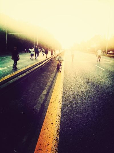 People on road at sunset