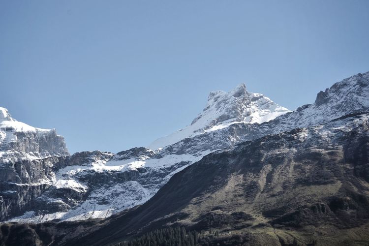 Scenic view of snowcapped mountains against clear sky