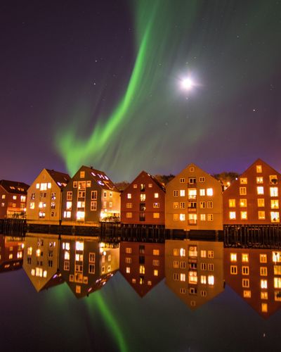 Scenic view of illuminated houses against sky at night