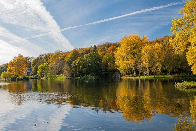 View of the autumn colours around the lake at stourhead gardens in wiltshire.