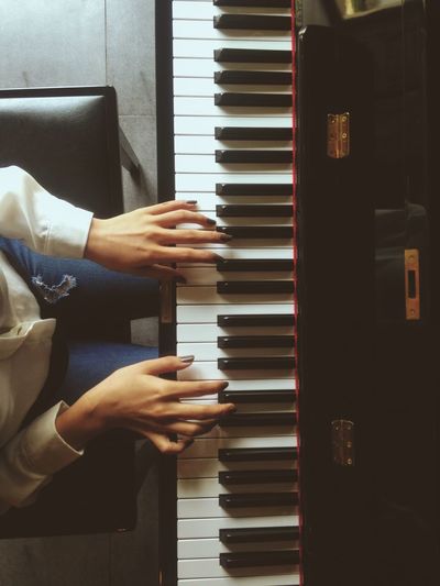 Midsection of woman playing piano