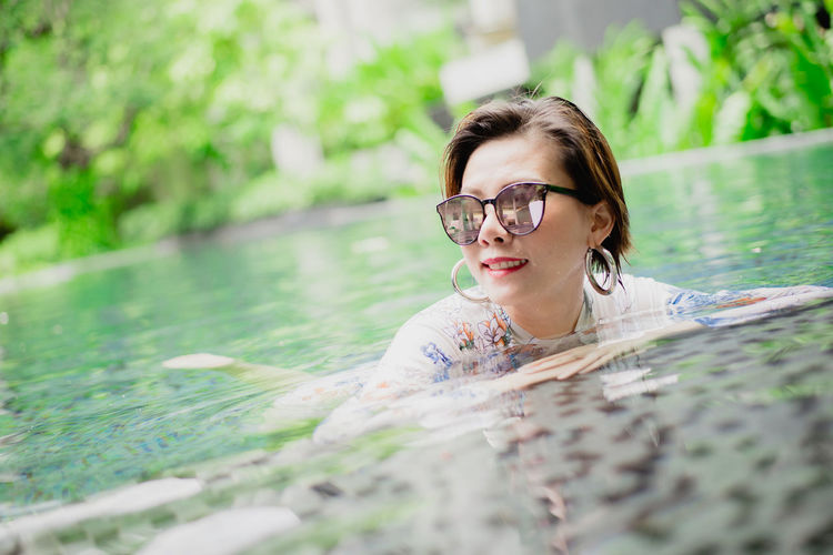 Portrait of woman swimming in pool