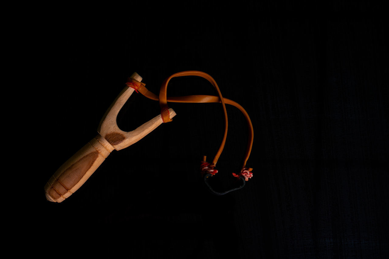 black background, studio shot, acrobat, indoors, hand, darkness, performing arts, dancing, copy space, one person, glasses