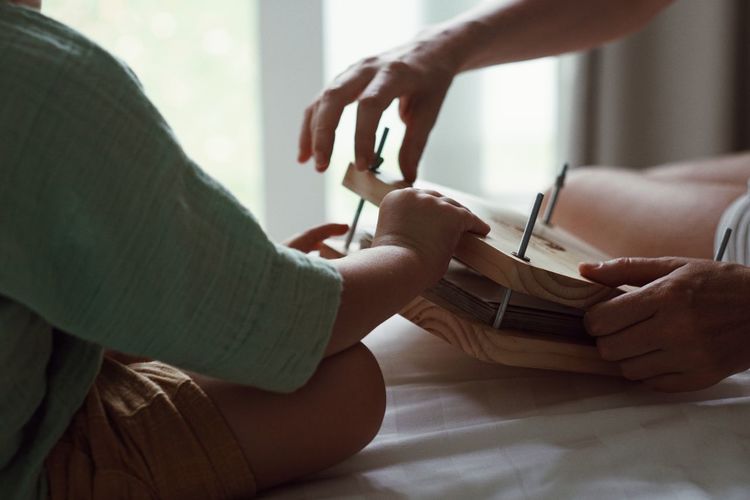 Rear view of woman doing yoga at home