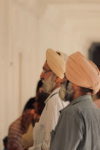 Side view of two pedestrians wearing turban 