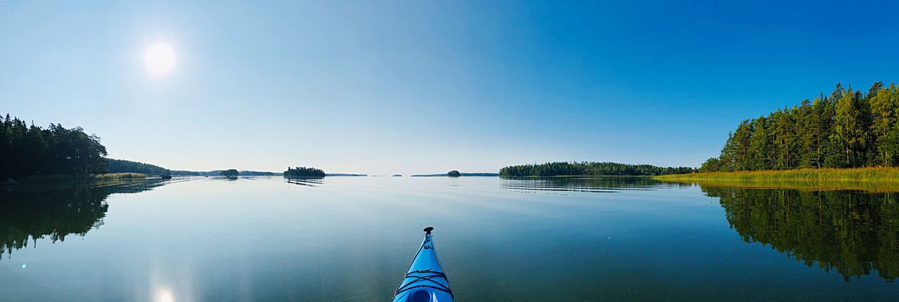 Kayaking against clear blue sky horizon