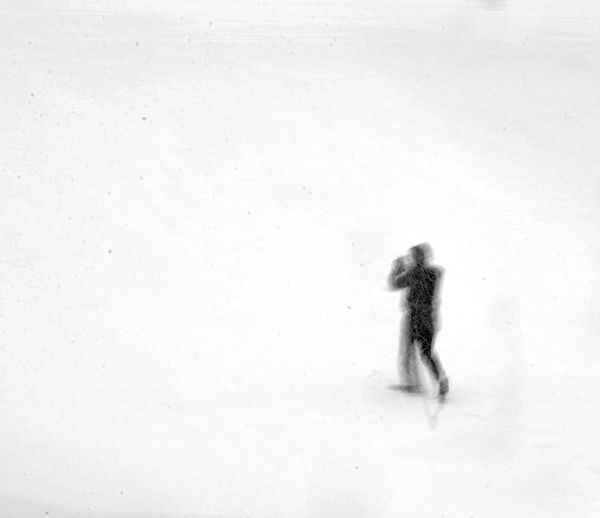 Blurred motion of person walking on snow