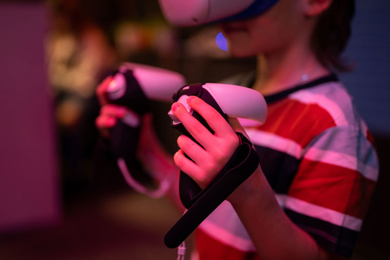 Vr game and virtual reality. kid boy gamer six years old fun playing on futuristic video game