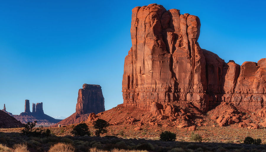Rock formations on mountain against blue sky monument valley 