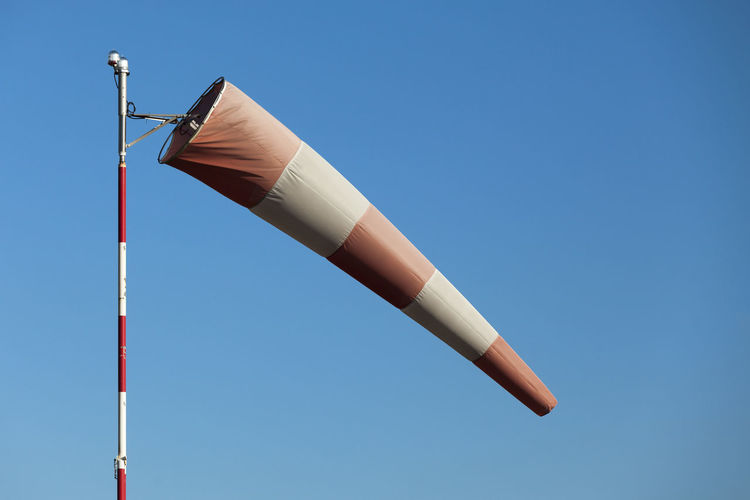 Close-up of an airfield windsock in moderate winds.