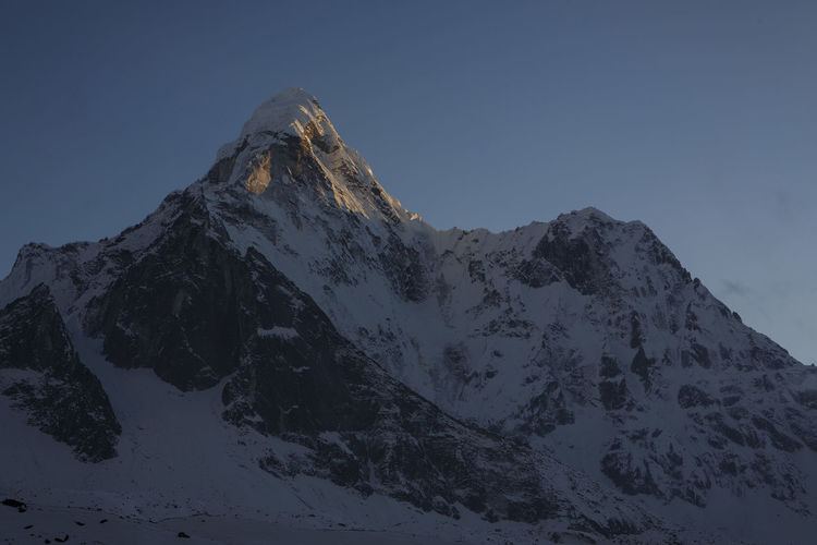 Alpenglow on the summit of ama dablam in nepal's khumbu valey.