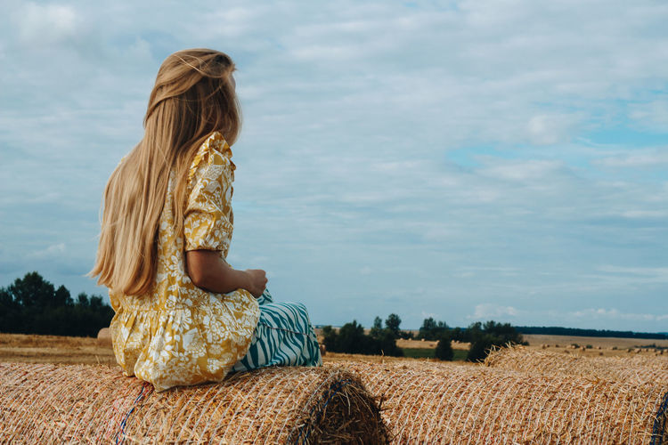 Woman sitting in field