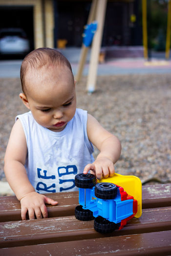 Portrait of cute boy playing with toy car