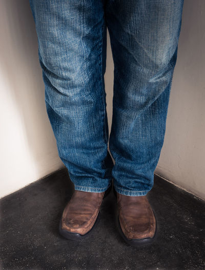 Low section of man wearing leather shoes